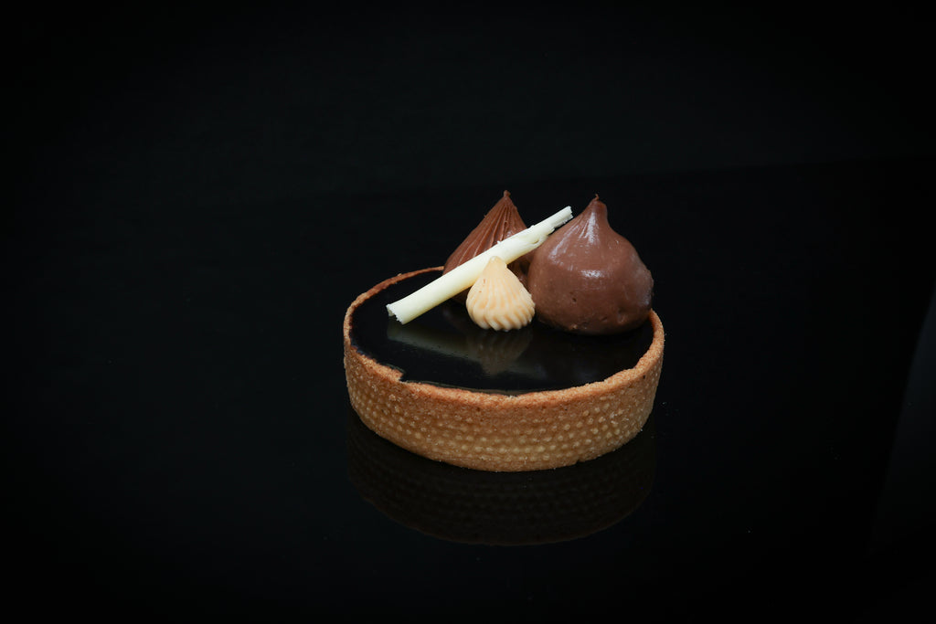 Chocolate dessert with a small bowl on a black background