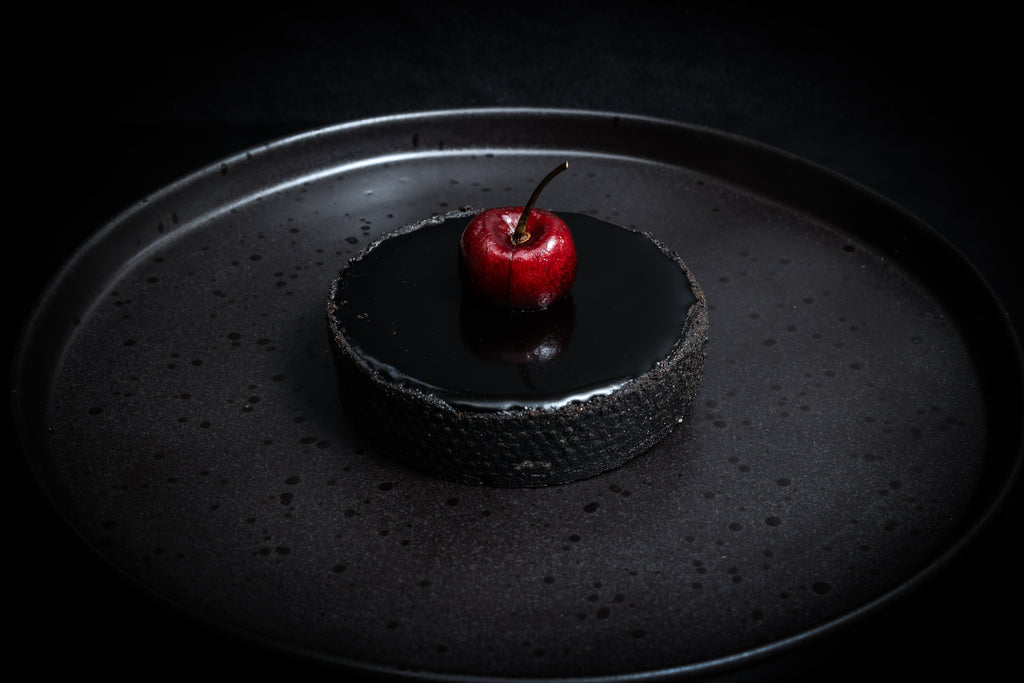 Cherry tart on a black plate