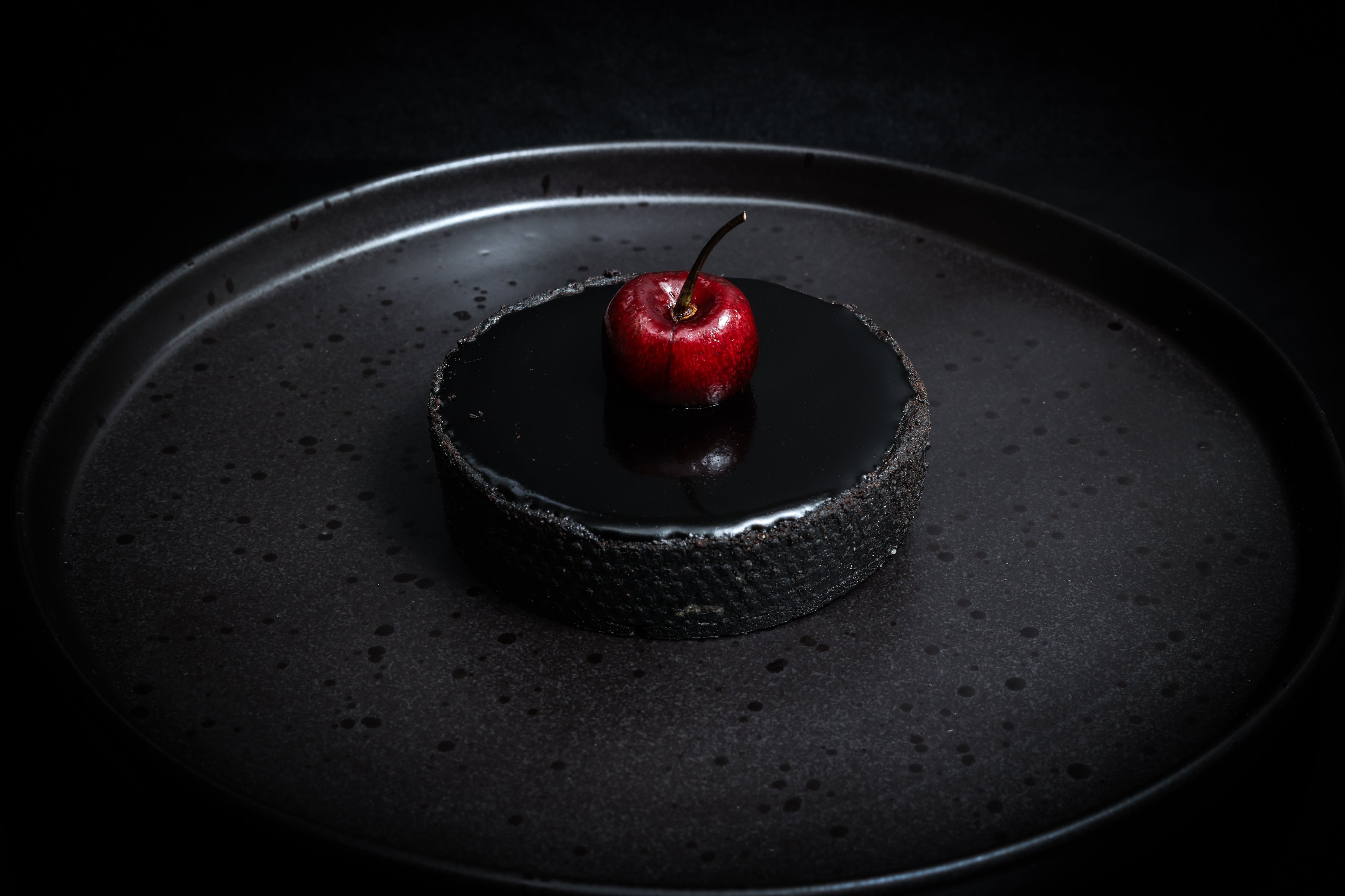 Cherry tart on a black plate
